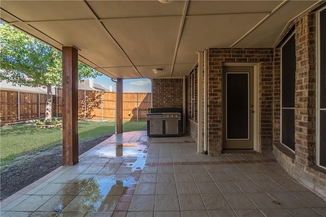 view of patio featuring fence and area for grilling