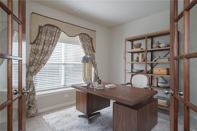 office space featuring french doors, carpet, visible vents, and baseboards