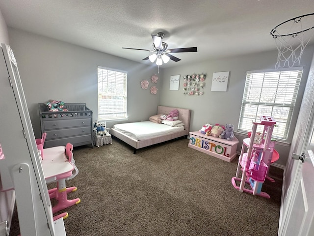 bedroom with carpet floors, ceiling fan, and a textured ceiling