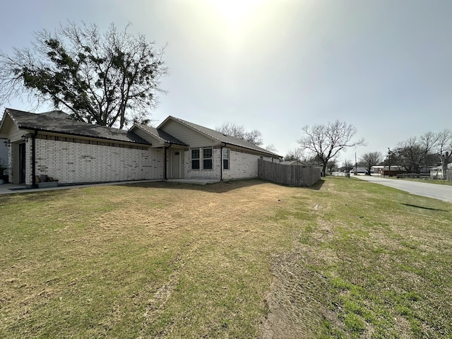 exterior space featuring fence and an attached garage