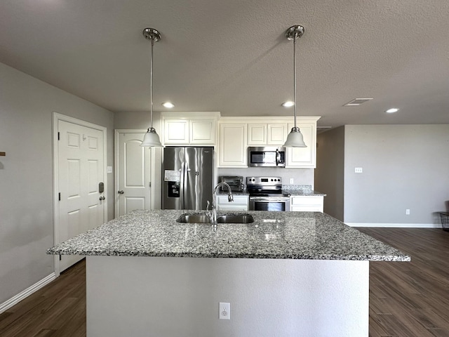 kitchen with stainless steel appliances, dark wood-style flooring, a sink, and visible vents