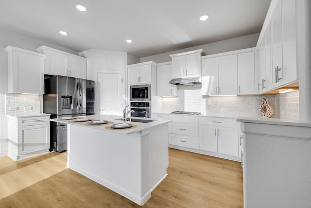 1536 Wolfberry Ln, Northlake, TX 76226 - kitchen featuring appliances with stainless steel finishes, wall chimney range hood, decorative backsplash, white cabinetry, and light countertops