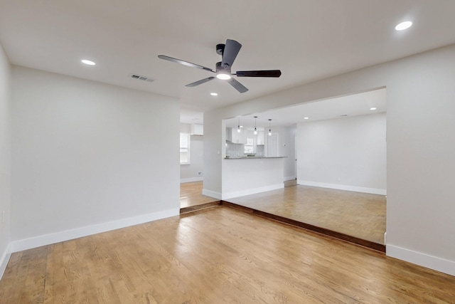 unfurnished living room featuring ceiling fan, recessed lighting, visible vents, baseboards, and light wood-style floors