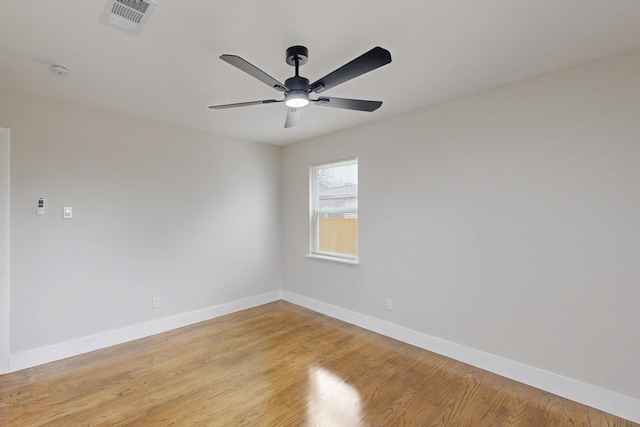 unfurnished room featuring baseboards, visible vents, and light wood-style floors