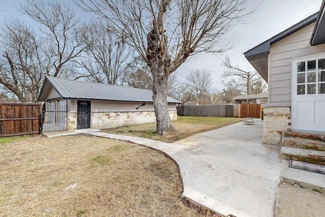 view of yard with entry steps, fence, and an outbuilding