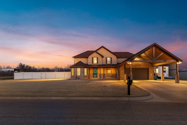 view of front of property featuring a garage, driveway, fence, and stucco siding