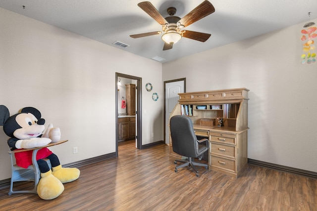 home office with a ceiling fan, baseboards, visible vents, and wood finished floors