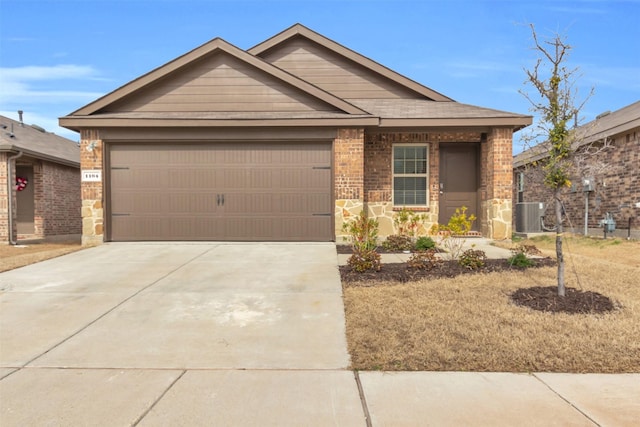 view of front of property featuring concrete driveway, stone siding, an attached garage, central AC, and brick siding