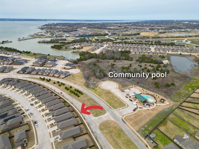 birds eye view of property with a water view and a residential view