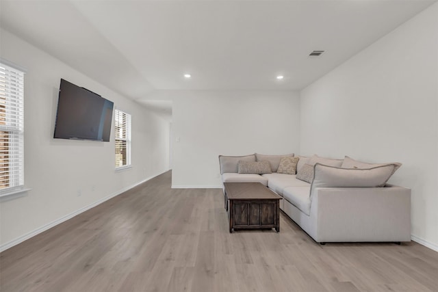 living room with recessed lighting, light wood-type flooring, visible vents, and baseboards