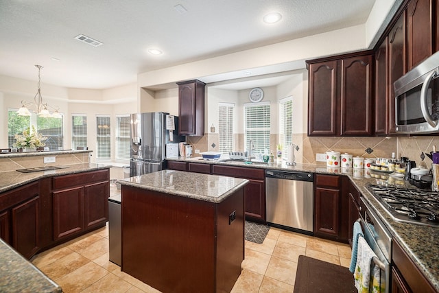 1202 Newcastle St, Roanoke, TX 76262 - kitchen with appliances with stainless steel finishes, healthy amount of natural light, decorative backsplash, and recessed lighting