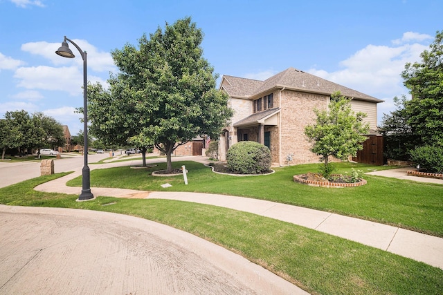 1202 Newcastle St, Roanoke, TX 76262 - view of front of property featuring a front lawn and brick siding