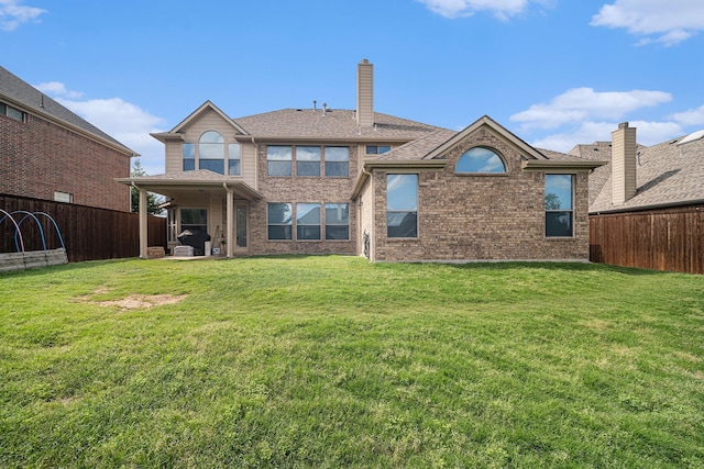 1202 Newcastle St, Roanoke, TX 76262 - back of house featuring a chimney, brick siding, and a patio