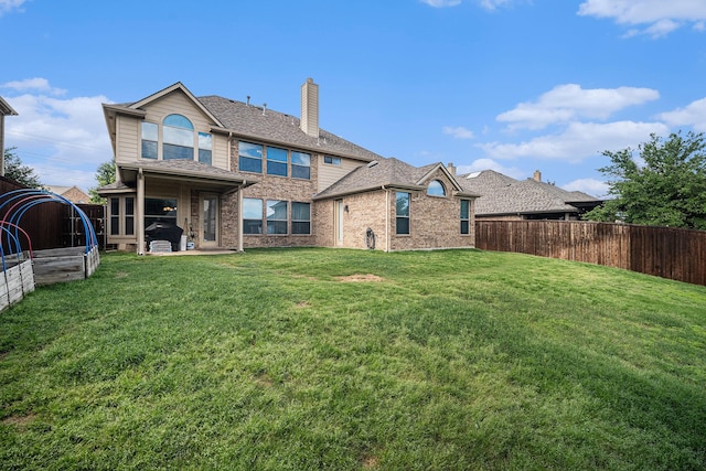 1202 Newcastle St, Roanoke, TX 76262 - back of property featuring a chimney, brick siding, a shingled roof, and a patio