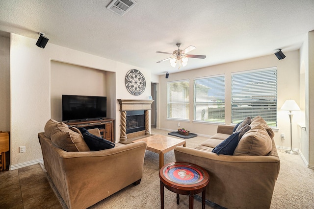 1202 Newcastle St, Roanoke, TX 76262 - carpeted living area featuring baseboards, a fireplace, a ceiling fan, and a textured ceiling