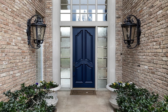 doorway to property with brick siding