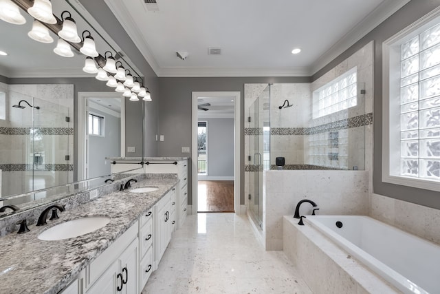 full bath featuring ornamental molding, a wealth of natural light, and a sink