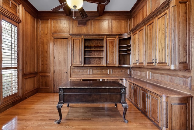 office area with light wood-style flooring, wooden walls, coffered ceiling, and beam ceiling