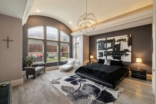 bedroom with lofted ceiling, light wood finished floors, baseboards, and an inviting chandelier