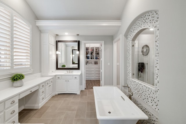 bathroom featuring a soaking tub, a closet, tiled shower, and vanity