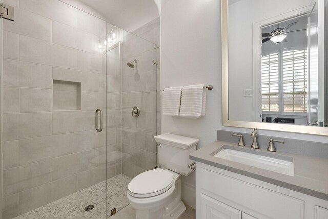 full bathroom with vanity, a shower stall, and toilet