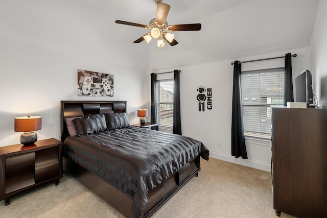 bedroom with light carpet, lofted ceiling, a ceiling fan, and baseboards