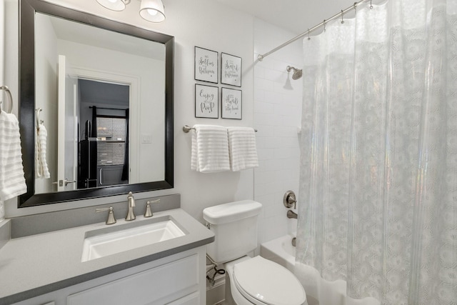 bathroom featuring toilet, shower / tub combo, and vanity