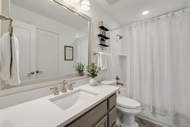 full bathroom featuring toilet, shower / tub combo, visible vents, and vanity