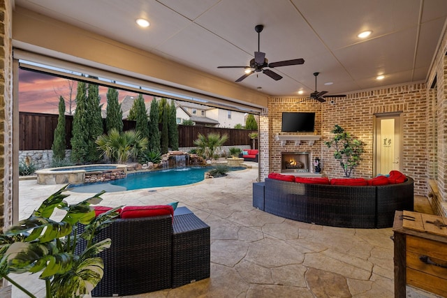 view of patio featuring a pool with connected hot tub, an outdoor living space with a fireplace, a fenced backyard, and a ceiling fan