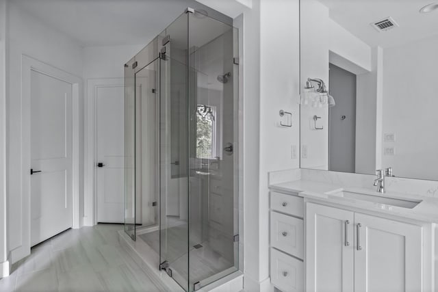 full bathroom featuring a stall shower, visible vents, and vanity