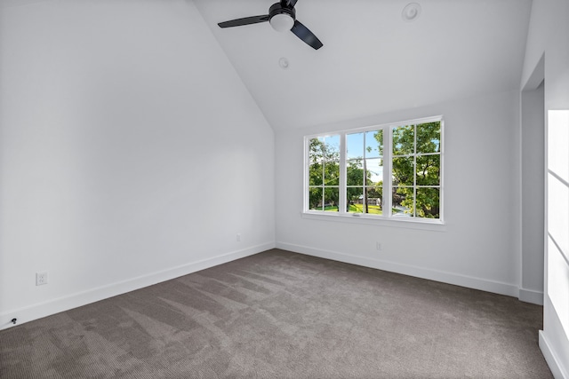 empty room featuring carpet floors, high vaulted ceiling, baseboards, and a ceiling fan