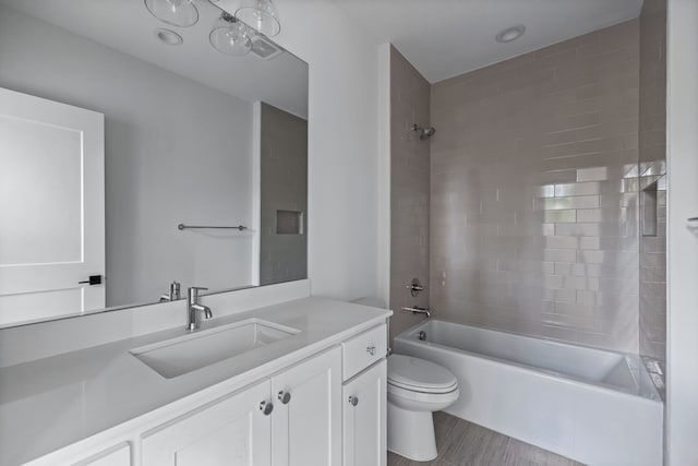 bathroom with shower / bathing tub combination, vanity, and toilet