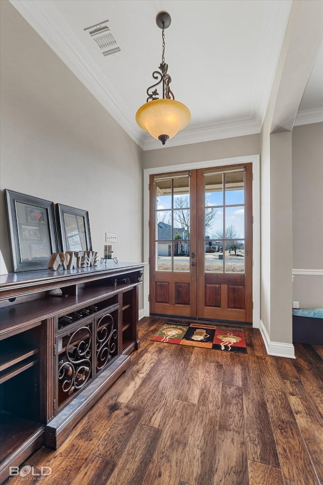 foyer with french doors, visible vents, ornamental molding, dark wood-type flooring, and baseboards