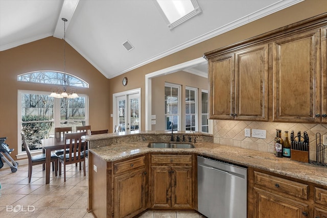 kitchen featuring light tile patterned floors, lofted ceiling, stainless steel dishwasher, brown cabinetry, and a sink