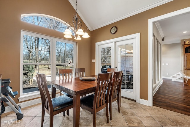 dining space featuring baseboards, light tile patterned flooring, an inviting chandelier, and crown molding