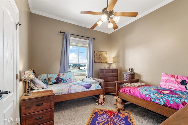 bedroom with carpet floors, ornamental molding, and a ceiling fan