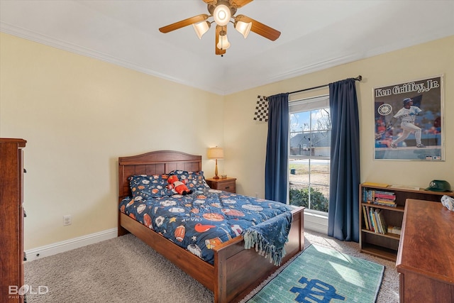 carpeted bedroom with ceiling fan, ornamental molding, multiple windows, and baseboards