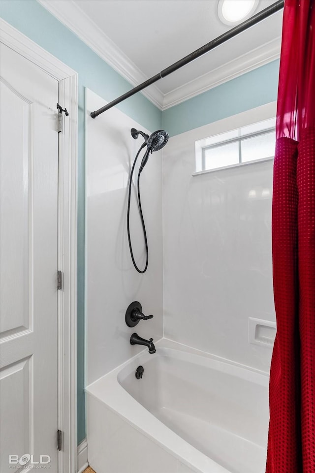 full bath featuring ornamental molding and washtub / shower combination