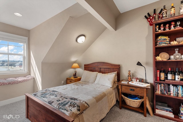 carpeted bedroom with vaulted ceiling and baseboards