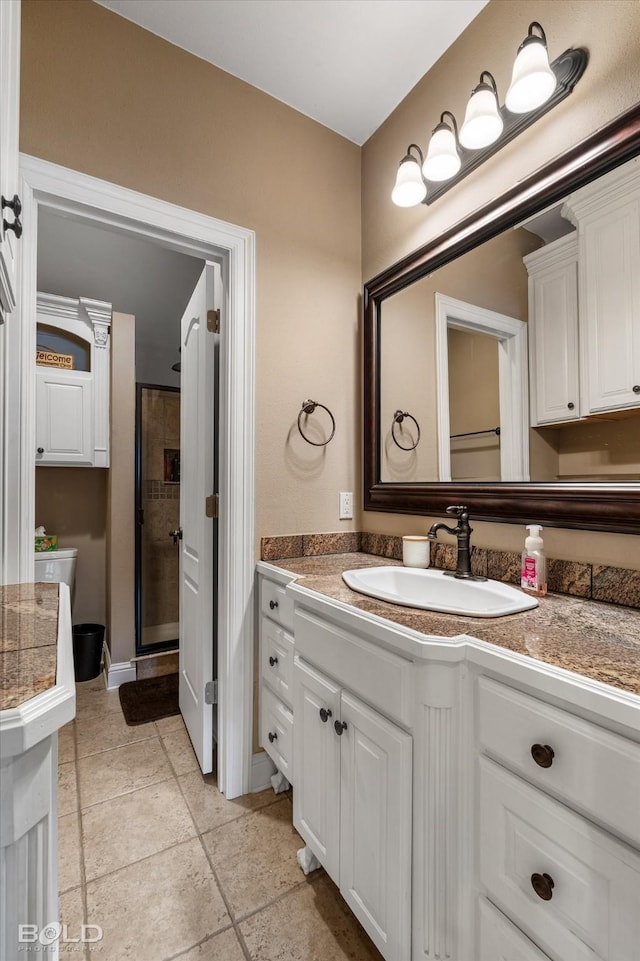 bathroom with a stall shower and vanity