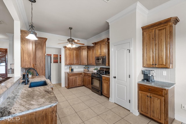 kitchen featuring light stone counters, a sink, brown cabinetry, black gas range oven, and crown molding