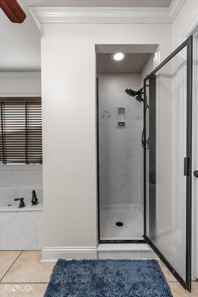 bathroom with a stall shower, tile patterned floors, and crown molding