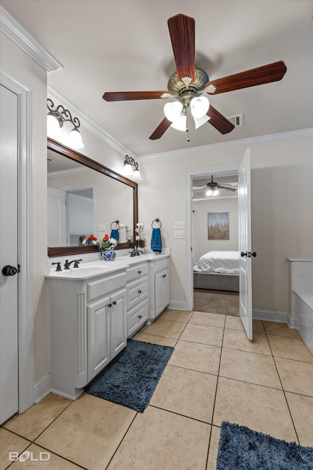 ensuite bathroom featuring double vanity, tile patterned floors, visible vents, and crown molding