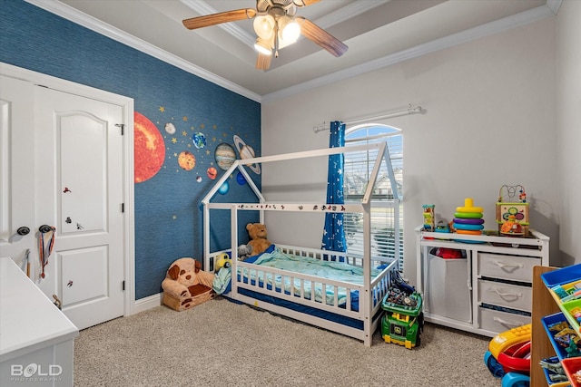 bedroom with carpet, a tray ceiling, crown molding, a ceiling fan, and wallpapered walls