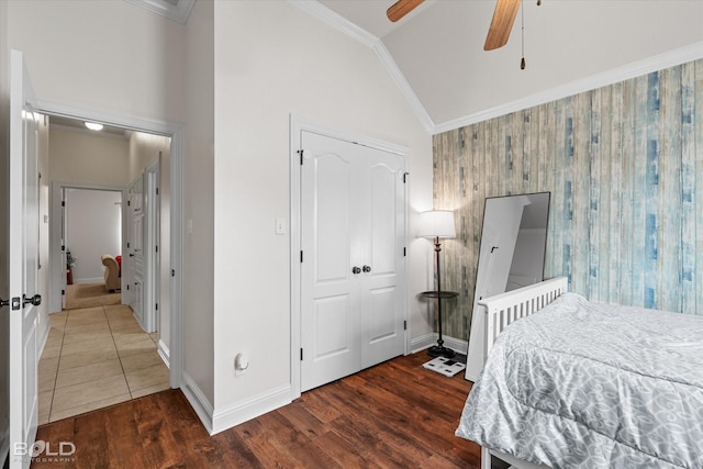 bedroom with ornamental molding, wood finished floors, and baseboards