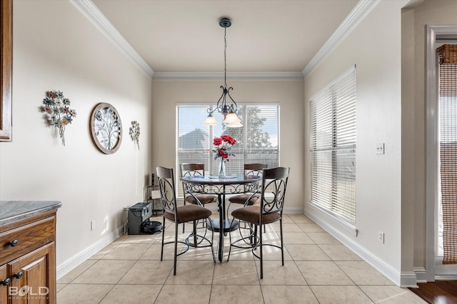 dining area with light tile patterned floors, ornamental molding, and baseboards