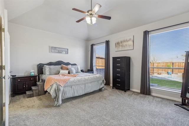 carpeted bedroom featuring a ceiling fan, baseboards, and vaulted ceiling