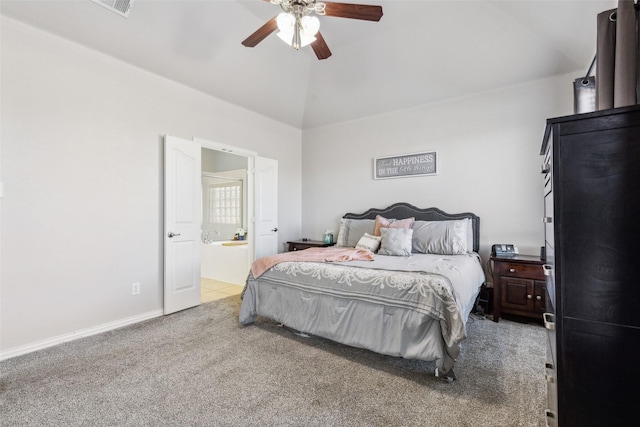 carpeted bedroom featuring ceiling fan, baseboards, ensuite bath, and vaulted ceiling