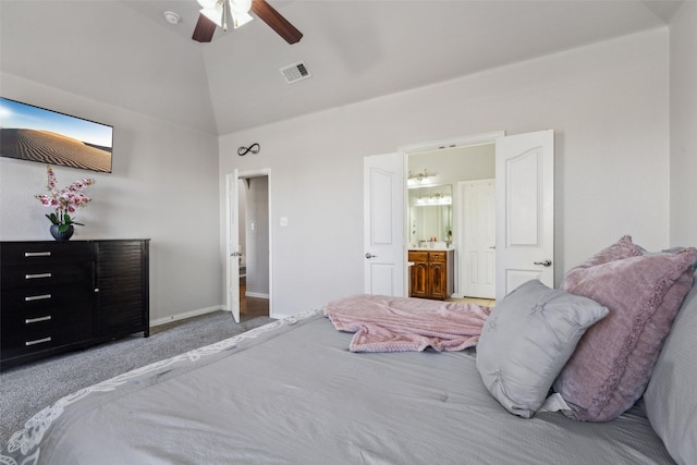 bedroom with carpet, visible vents, baseboards, vaulted ceiling, and connected bathroom