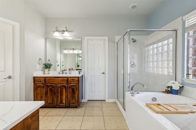 bathroom featuring tile patterned floors, a shower stall, a bath, and vanity